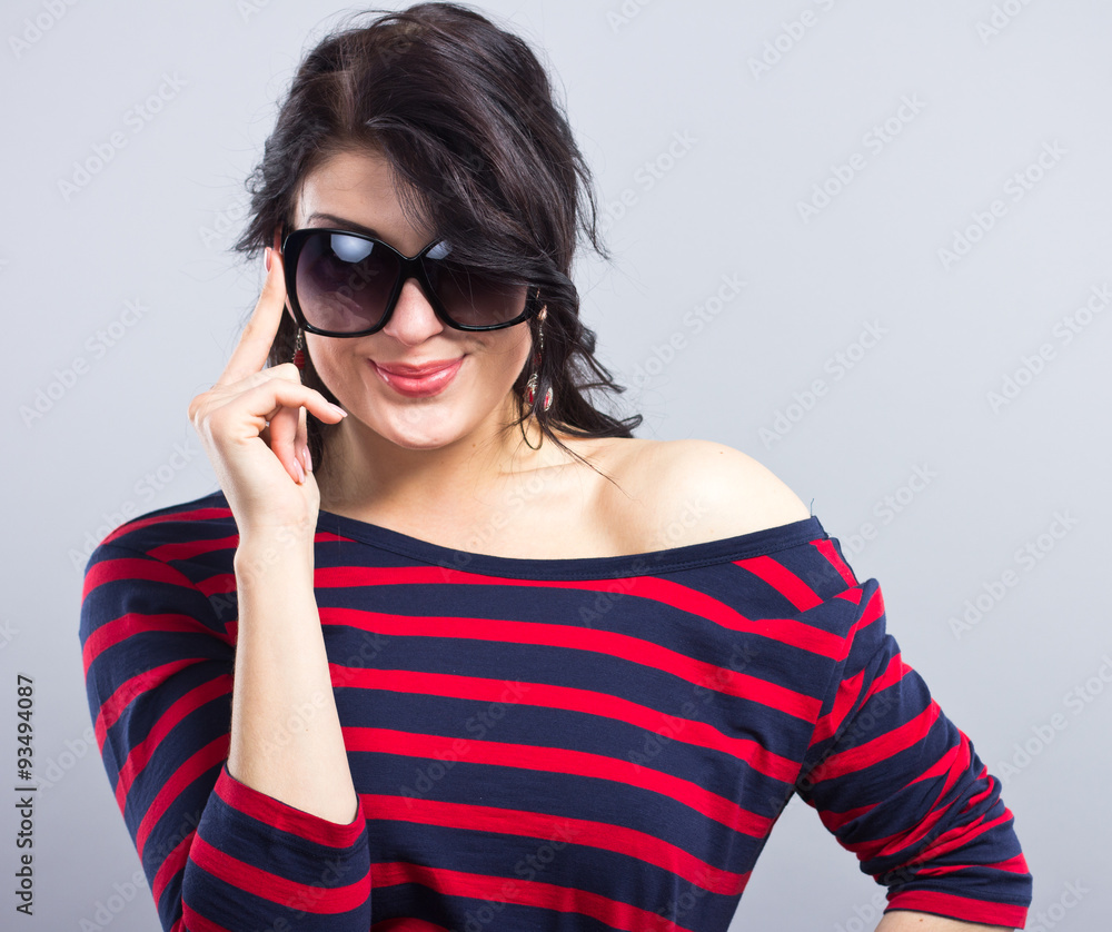 Beautiful brunette in a blue dress with red stripes. Fashion. Portrait of a young girl in sunglasses.
Beautiful brunette in a blue dress with red stripes. Fashion. Portrait of a young girl in sunglasses.