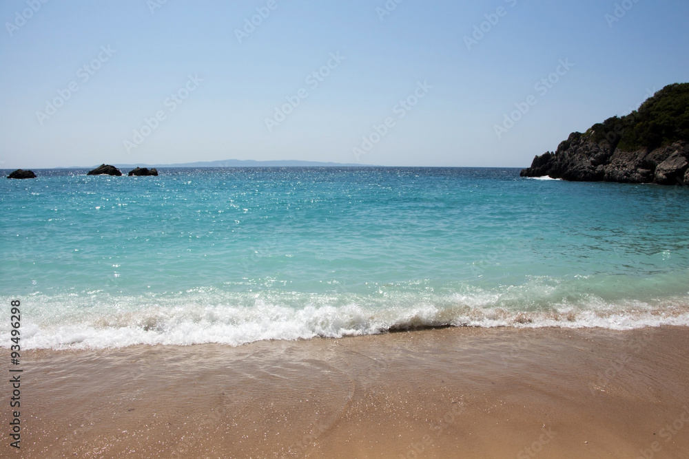 Scenic of a bay with turquoise waters and wet sand