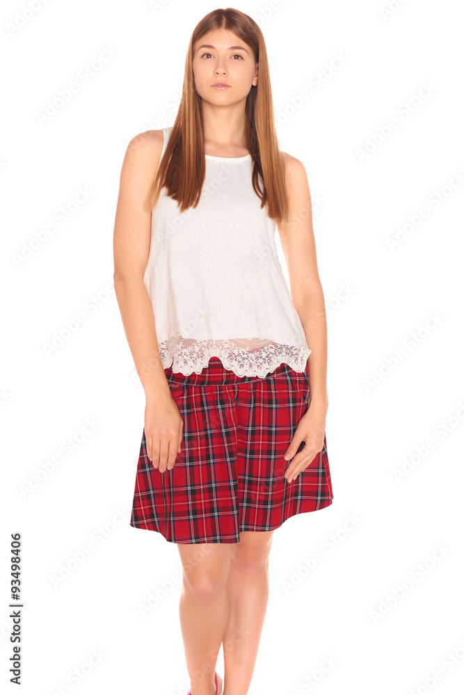 Pretty girl in a vest and skirt behind white wall Pretty girl in a vest and skirt behind white wall