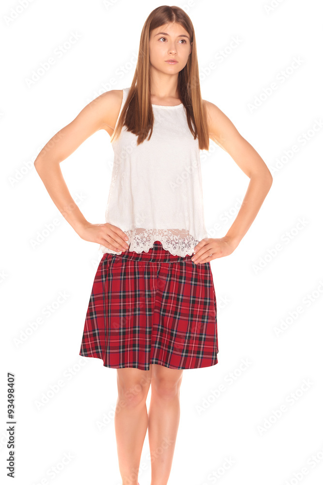Pretty girl in a vest and skirt behind white wall Pretty girl in a vest and skirt behind white wall