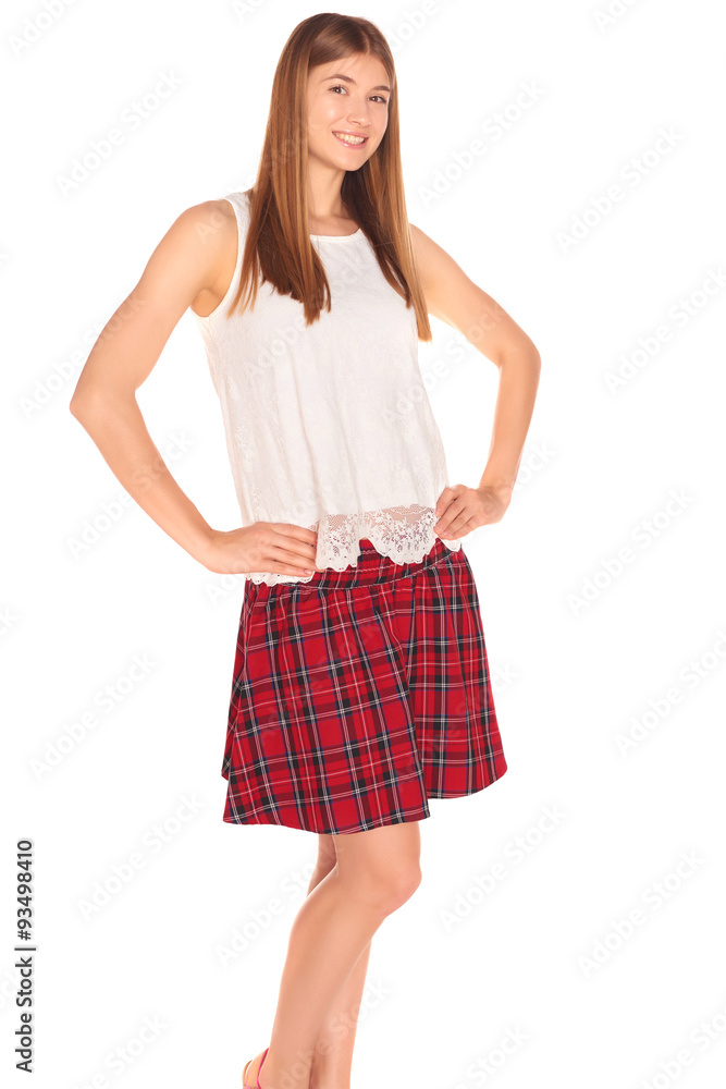 Pretty girl in a vest and skirt behind white wall Pretty girl in a vest and skirt behind white wall