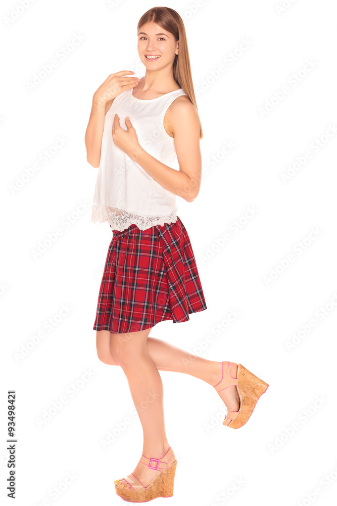Pretty girl in a vest and skirt behind white wall Pretty girl in a vest and skirt behind white wall