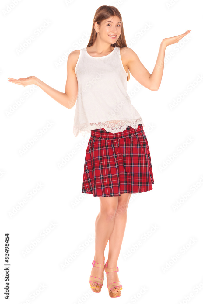 Pretty girl in a vest and skirt behind white wall Pretty girl in a vest and skirt behind white wall