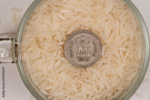 White steamed rice in a glass mug and five Indian rupees. Photo is ideal for website design or Indian sushi bar