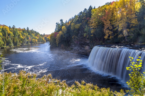 Tahquamenon Falls in Michigan's eastern Upper Peninsula seen with colorful fall foliage. This beautiful waterfall is said to be the second largest in the United States east of the Mississippi River.