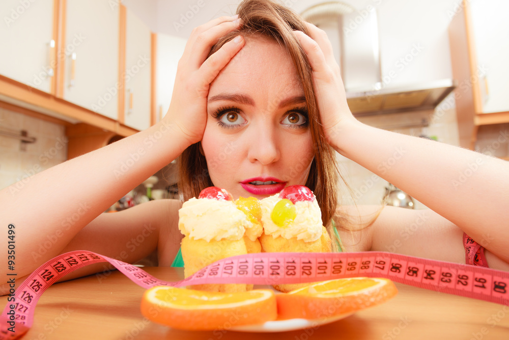 Woman with tape measure and cake. Diet dilemma. - obrazy, fototapety, plakaty 