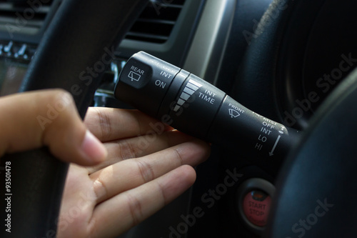 man hand use the signal switch. Car interior detail.