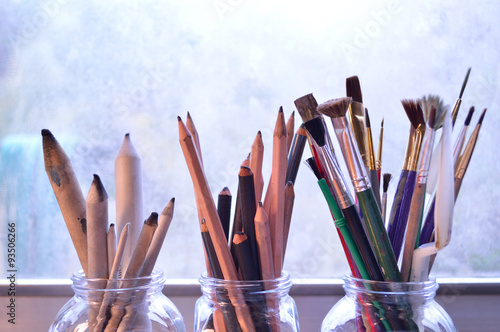 Fine art supplies: Three bouquets of drawing and painting tools.