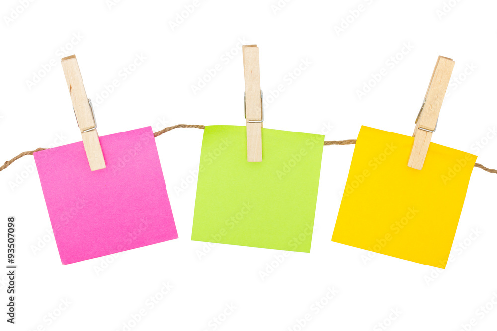 Colorful sticky notes with clothespins isolated on white backgro Colorful sticky notes with clothespins isolated on white backgro