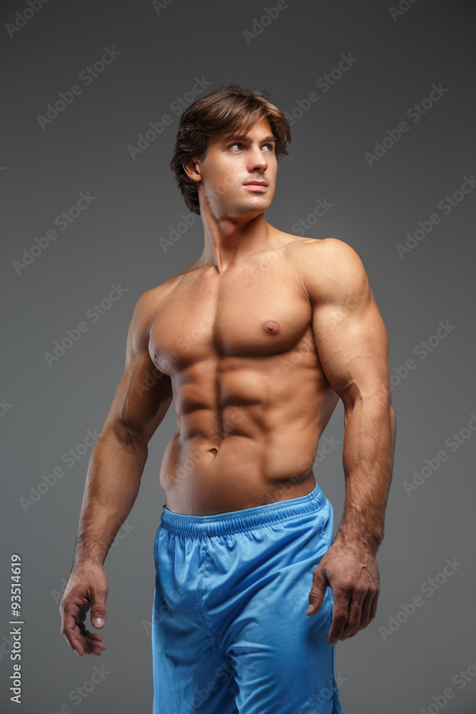 Shirtles muscular man in blue shorts.