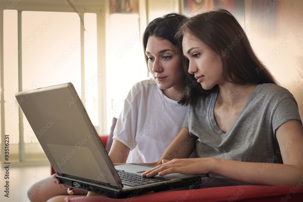 Friends using a laptop Friends using a laptop