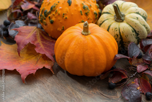 seasonal pumpkin with autumn leaves on table
