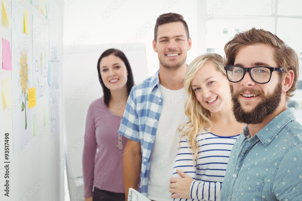 Portrait of smiling business people next to sticky notes Portrait of smiling business people next to sticky notes