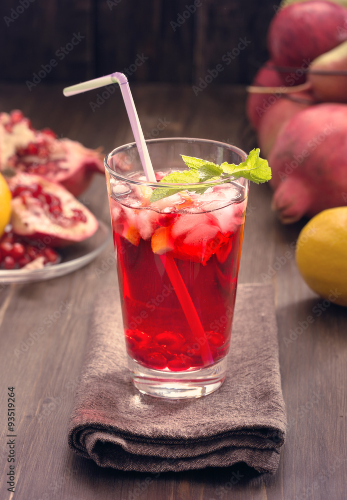 Fototapeta premium Pomegranate with lemon and ice toned