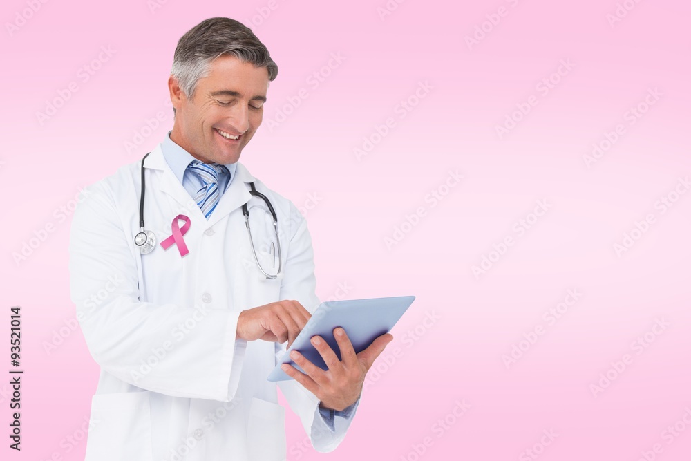 Composite image of happy doctor using tablet pc Composite image of happy doctor using tablet pc