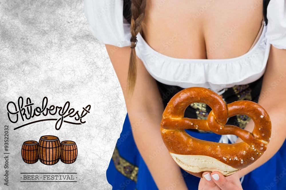 Composite image of oktoberfest girl bending and showing pretzel Composite image of oktoberfest girl bending and showing pretzel