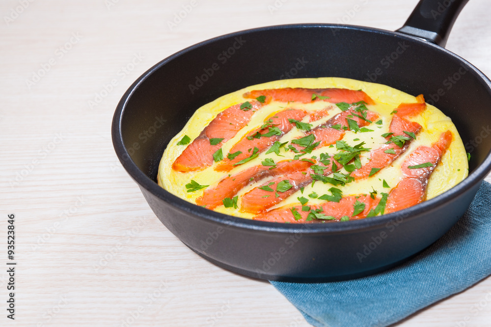 omelet with smoked salmon in a frying pan omelet with smoked salmon in a frying pan