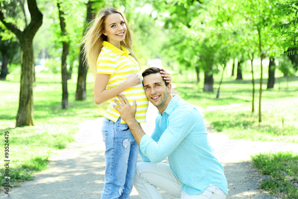 Fototapeta premium Young pregnant woman with husband in park