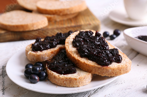 Fresh toast with butter and jam on table close up