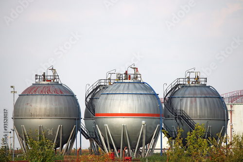 four oil tanks on field