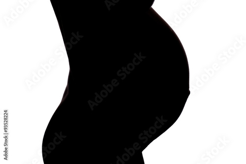 Silhouette vom Bauch einer schwangeren Frau photo