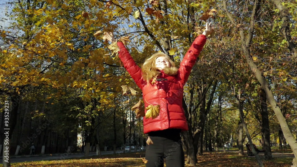 Girl throwing leaves in Autumn in slow motion Girl throwing leaves in Autumn in slow motion
