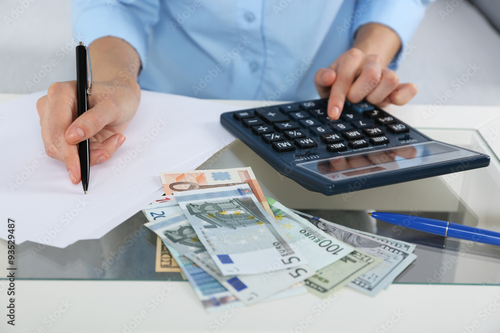 Fototapeta premium Accounting concept.Analyzing finance report with calculator