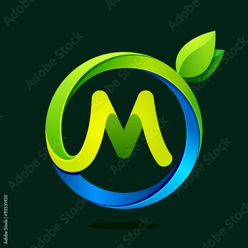 M letter with green leaves and water waves.