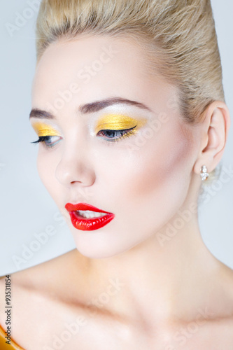 Pretty blonde female model face with artistic make up