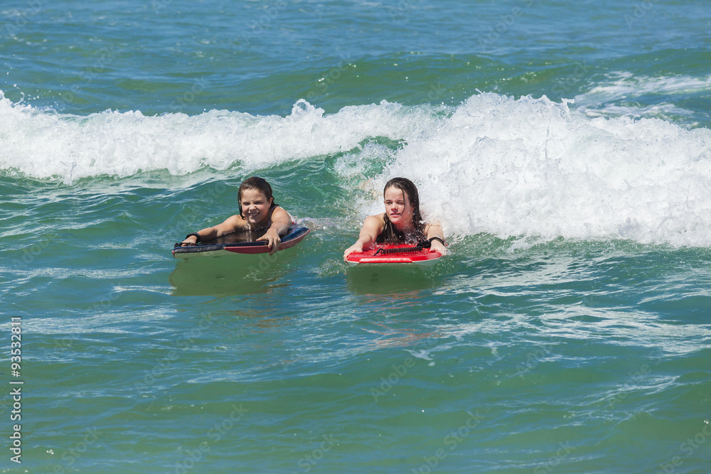 Girls Surfing waves holidays body boarding fun