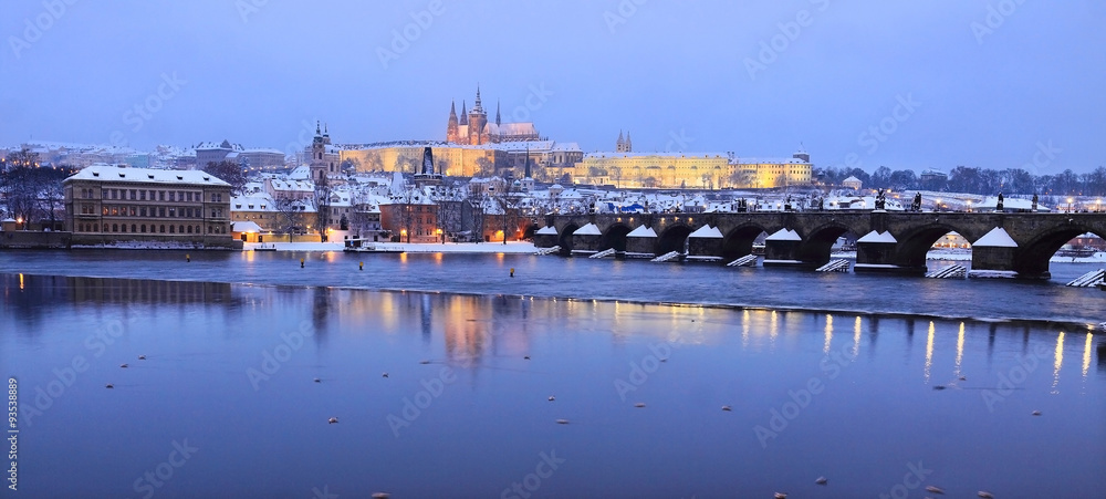 Evening romantic colorful snowy Prague gothic Castle with Charles Bridge, Czech Republic