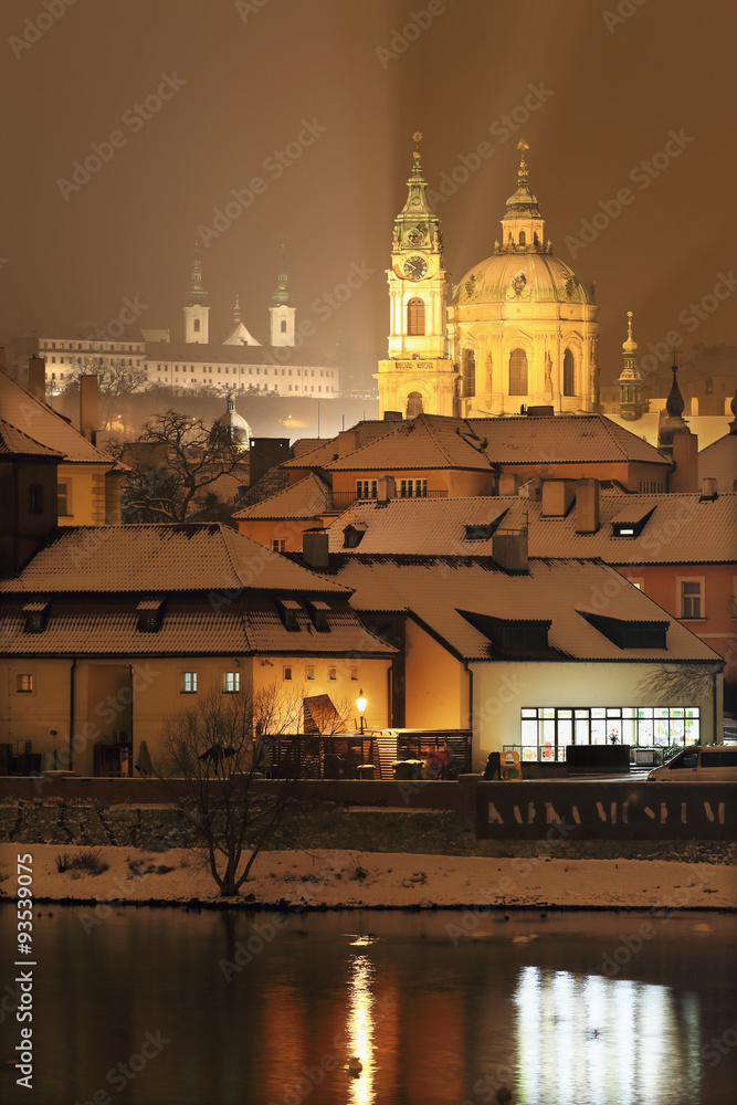 Night romantic snowy Prague St. Nicholas' Cathedral, Czech republic