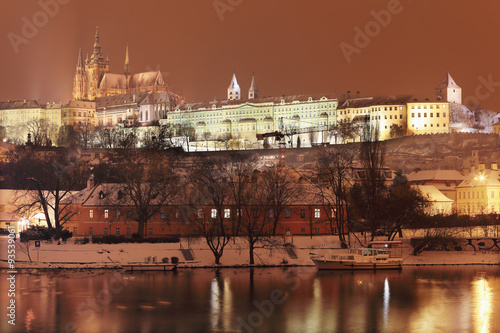 Night colorful romantic snowy Prague gothic Castle above River Vltava, Czech republic