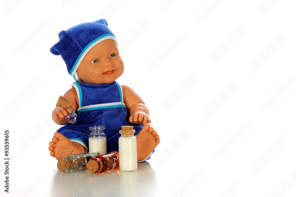 Baby doll holding teats and litle milk bottles Baby doll holding teats and litle milk bottles