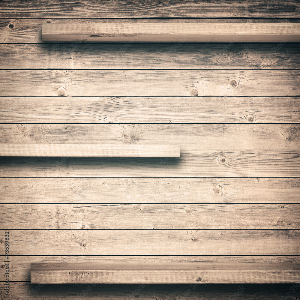 Obraz premium Old brown empty shelf on wooden wall