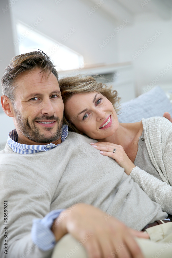 Mature couple relaxing in couch at home Mature couple relaxing in couch at home