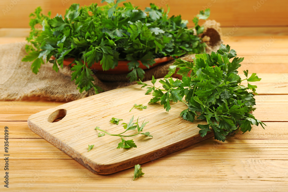 Fresh parsley on wooden cutting board Fresh parsley on wooden cutting board