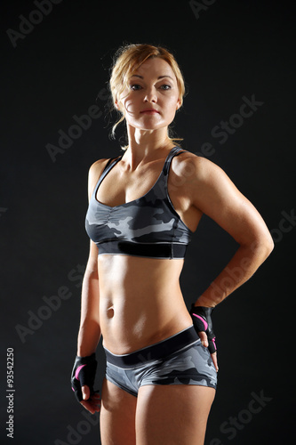 Athletic woman on dark background © Africa Studio