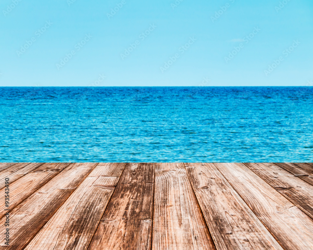 Coconut plank under image of peaceful sea with clear sky.