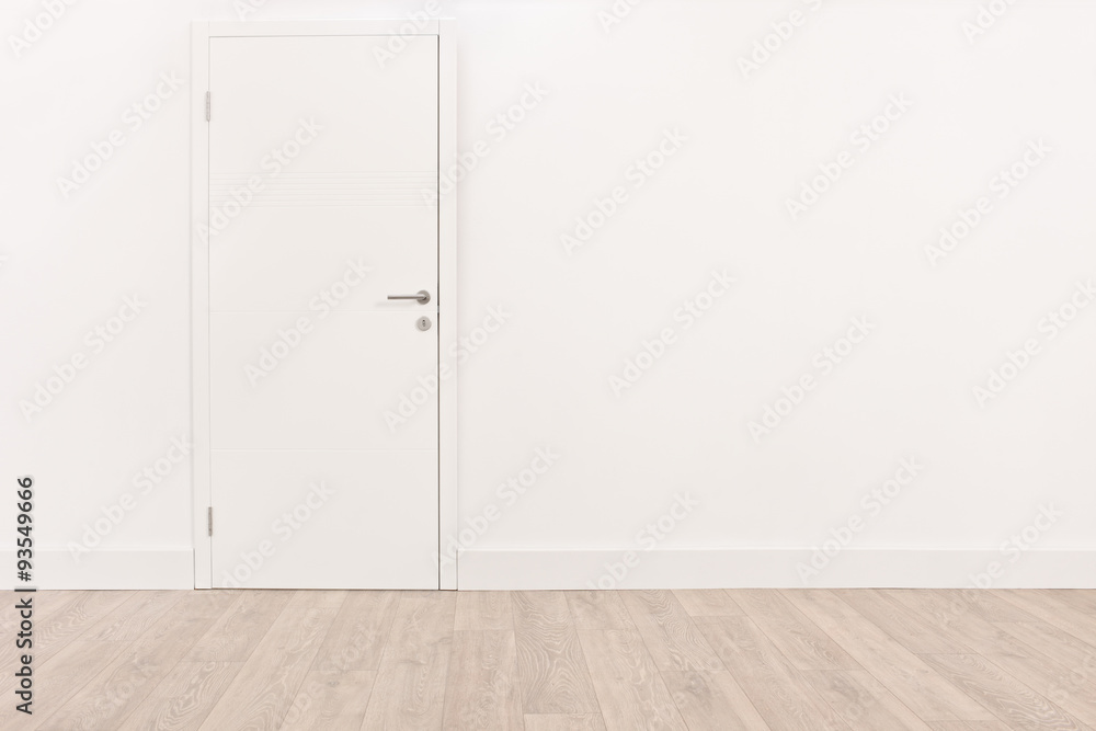 Obraz premium White door and a light brown hardwood floor