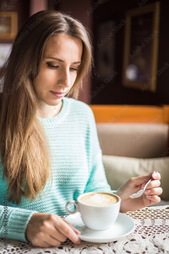 Young beautiful lady having coffee break in the cafe. Young beautiful lady having coffee break in the cafe.