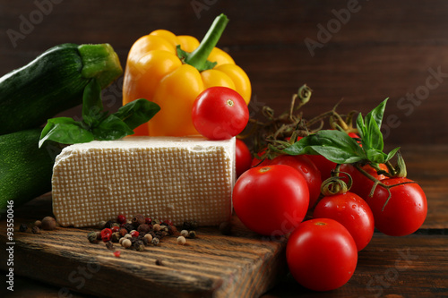 Fresh ingredients for preparing zucchini rolls on wooden background