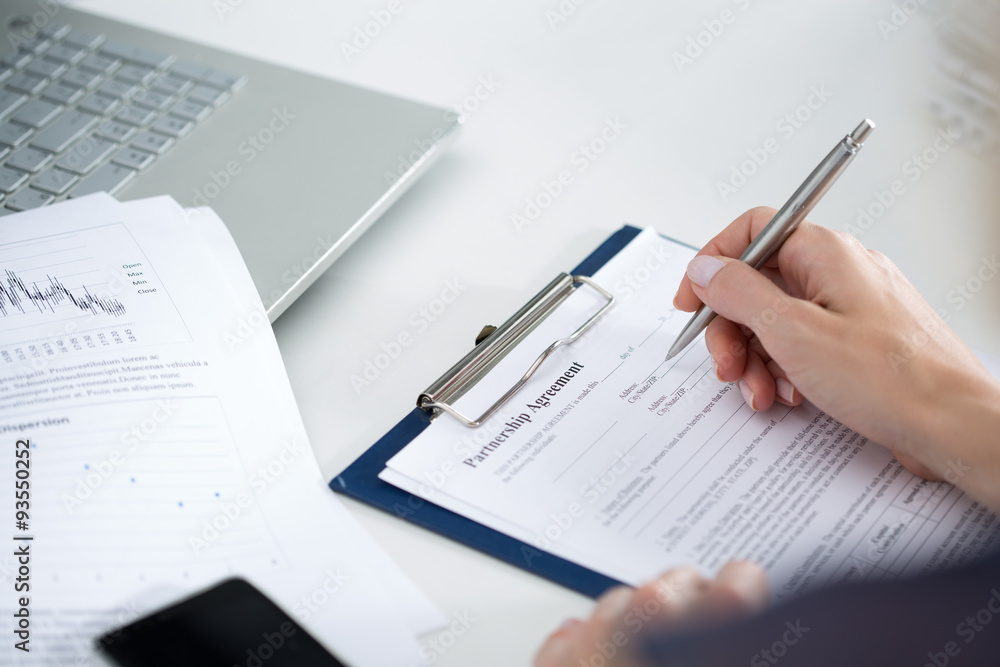 Business woman filling partnership agreement Business woman filling partnership agreement