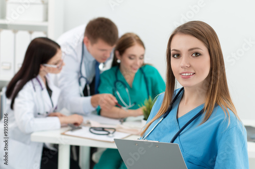 Portrait of smiling female medicine doctor holding folder with d