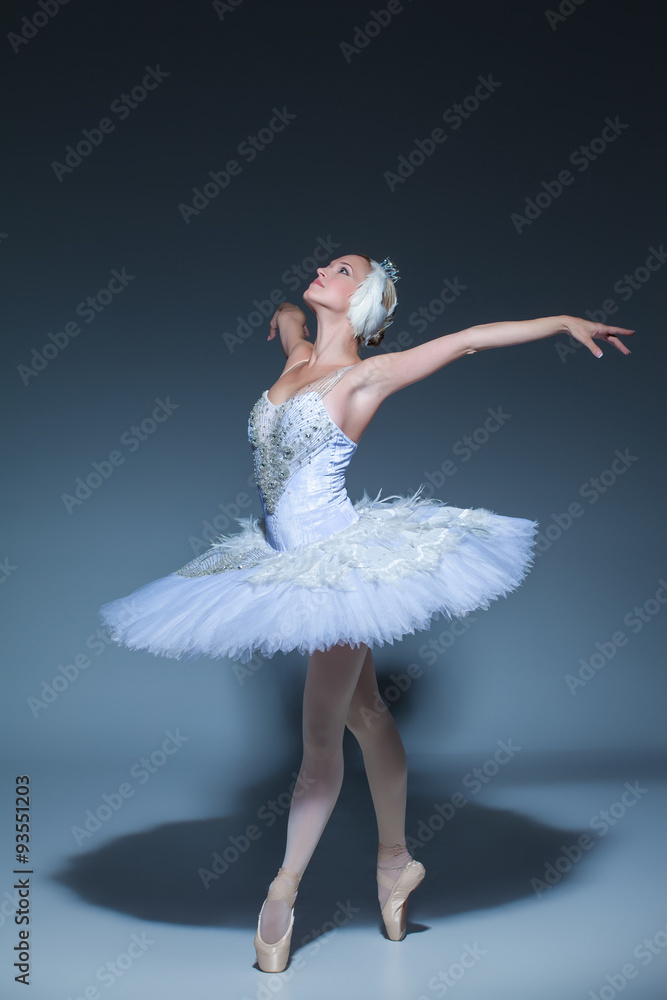 Naklejka premium Portrait of the ballerina in ballet tatu on blue background