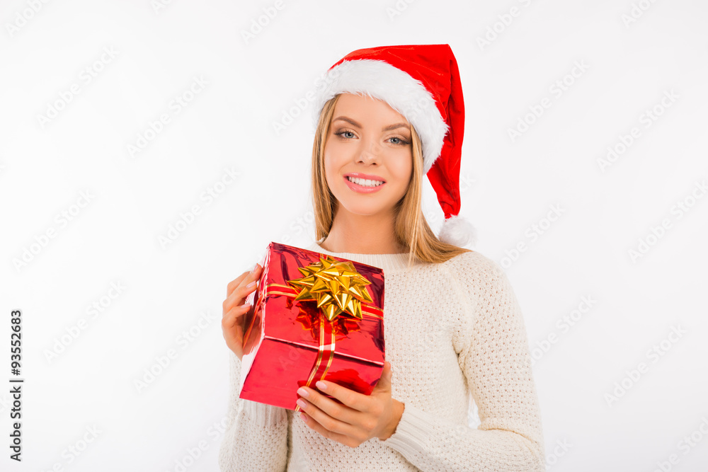 Cute young woman in santa hat with Christmas presents Cute young woman in santa hat with Christmas presents