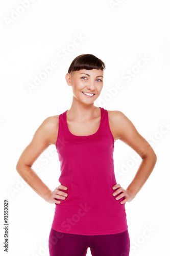 Young woman in fitness outfit with smile over white background. © Wisiel