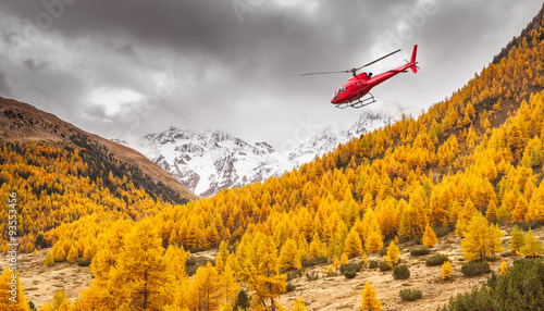 Fototapeta Val Nera - Livigno (IT) - czerwony helikopter w locie