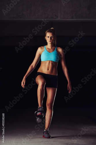 Fit bodybuilder exercising her legs