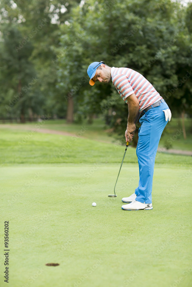 Fototapeta premium Young man playing golf